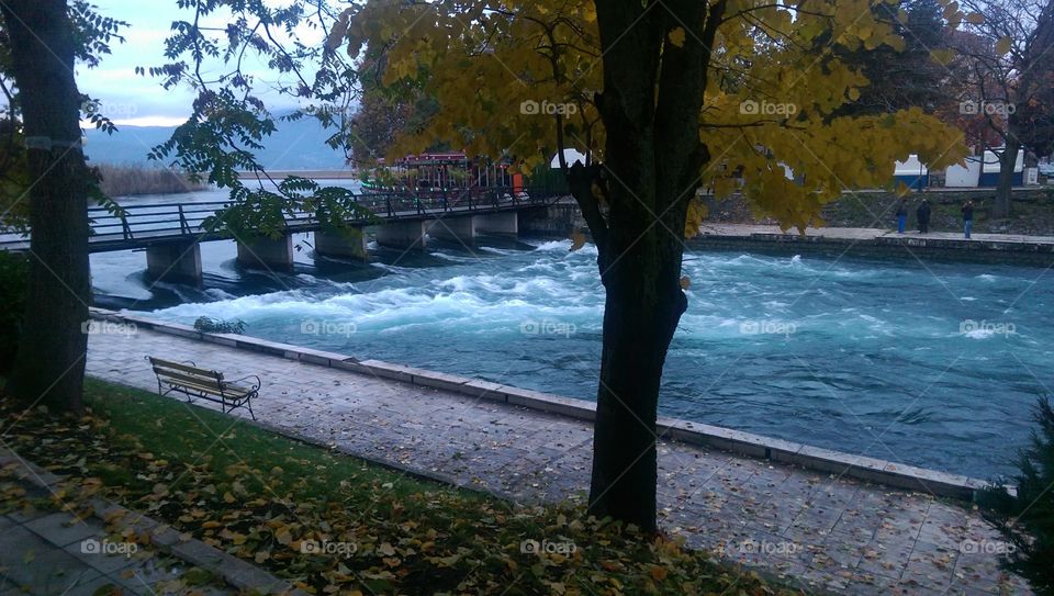 A picture of the beautiful small city of Struga in fall. The river that croses the city goes by a lot of bridges but this one is more special as it controls the waterflow from the lake to the river. The colours are very fall-ish and the river makes it even better.