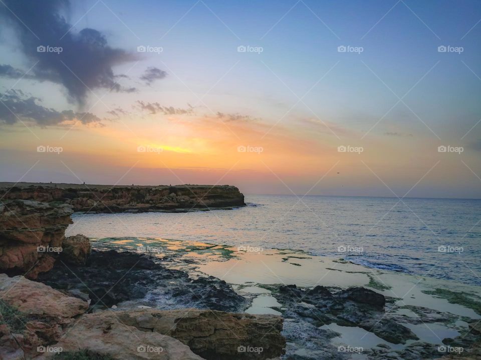 Sunrise glow over the sea and cliffs