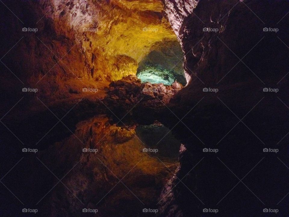 Light up cave mirroring in a pool of water