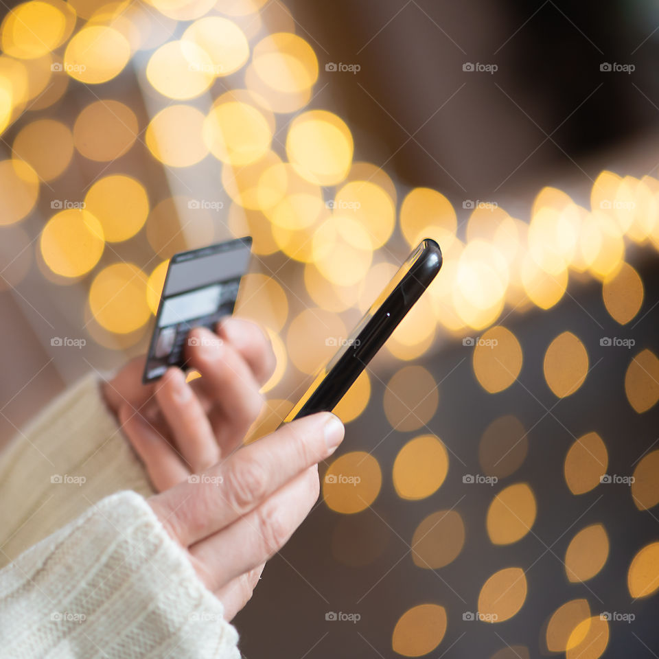 Woman holding phone and credit card