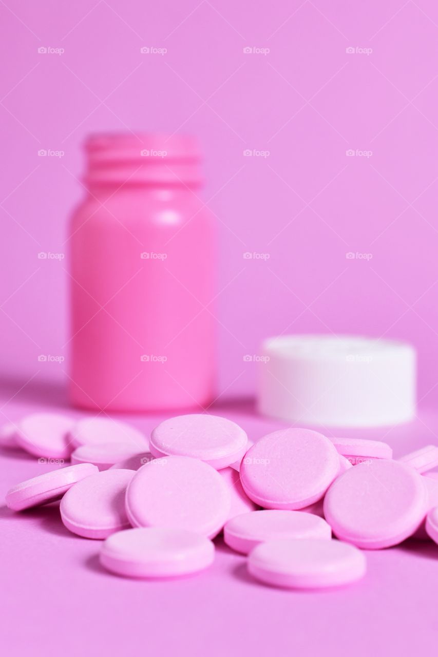 Pink tablets on a pink background 