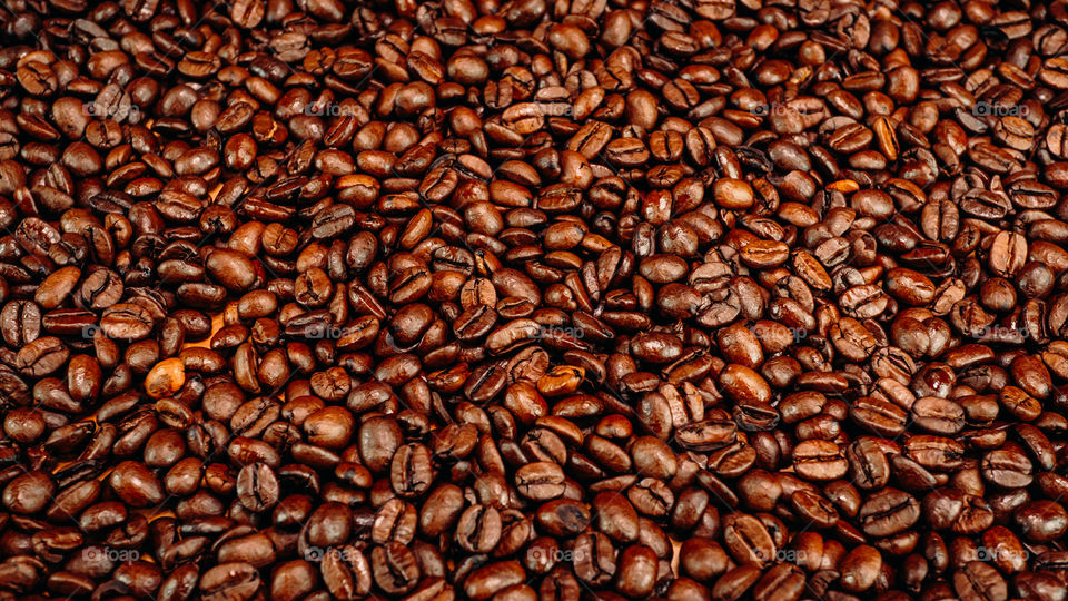 Roasted coffee beans on table