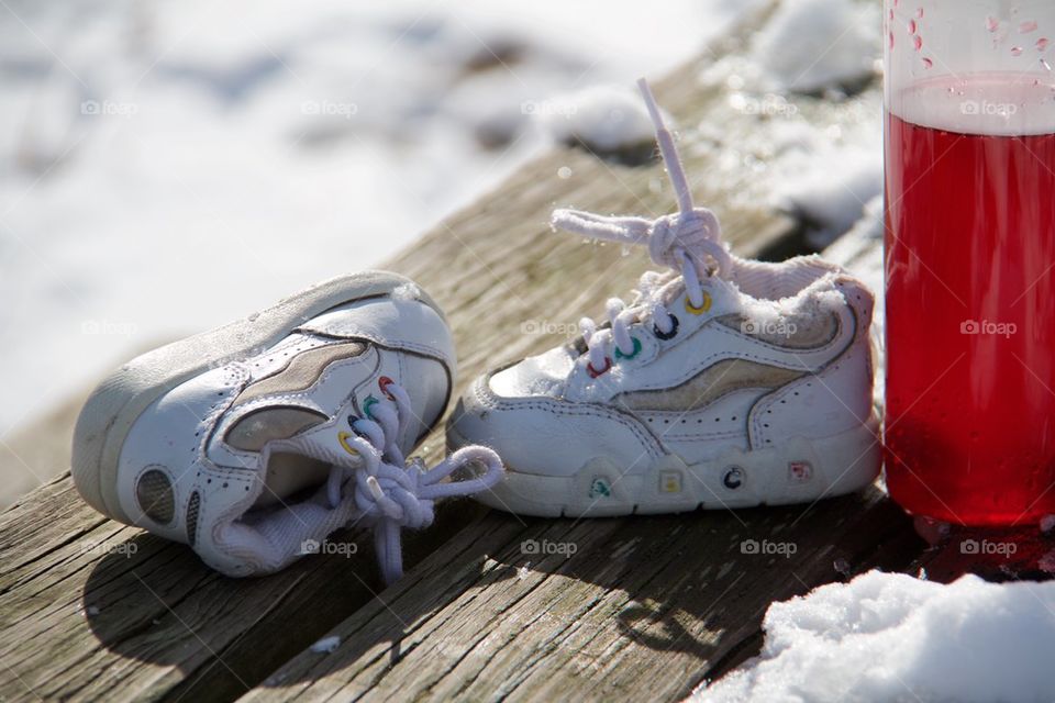 Children s shoes in the snow 