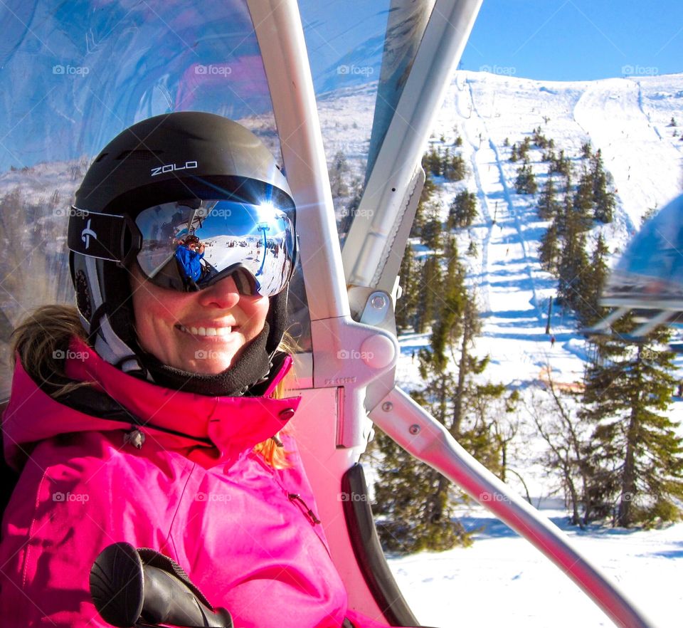 Woman enjoying ski lift in winter