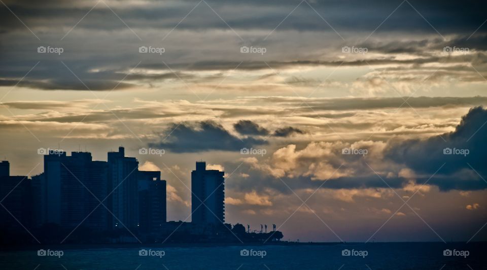 The cloudy sunset and the city