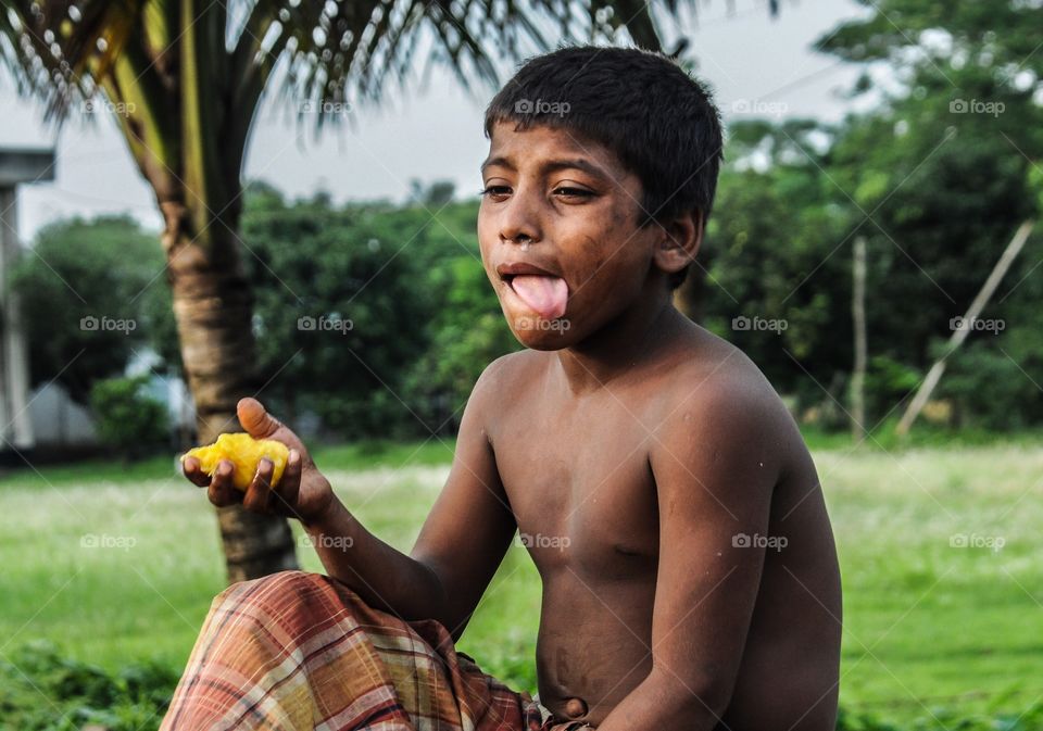 Portrait of boy eating fruit