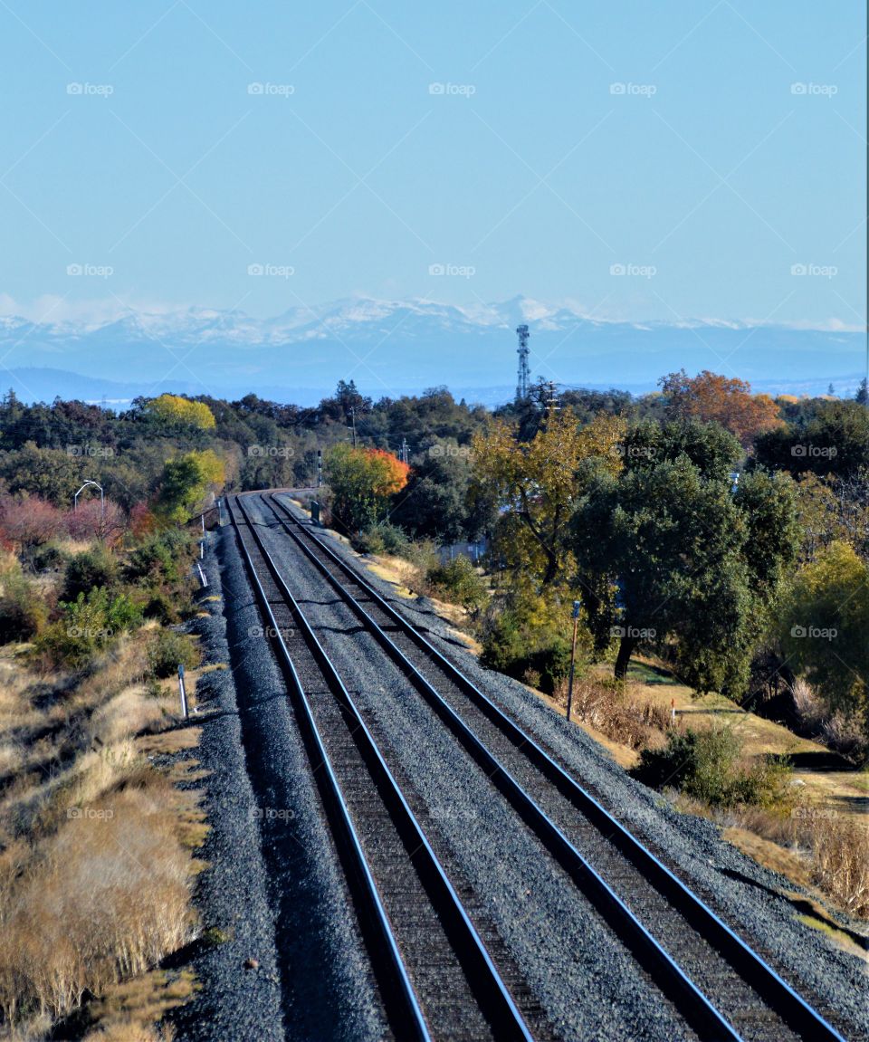 train tracks to the snow cap mountains