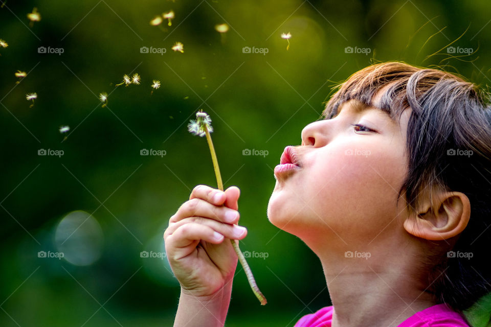 Cute girl with dandelion