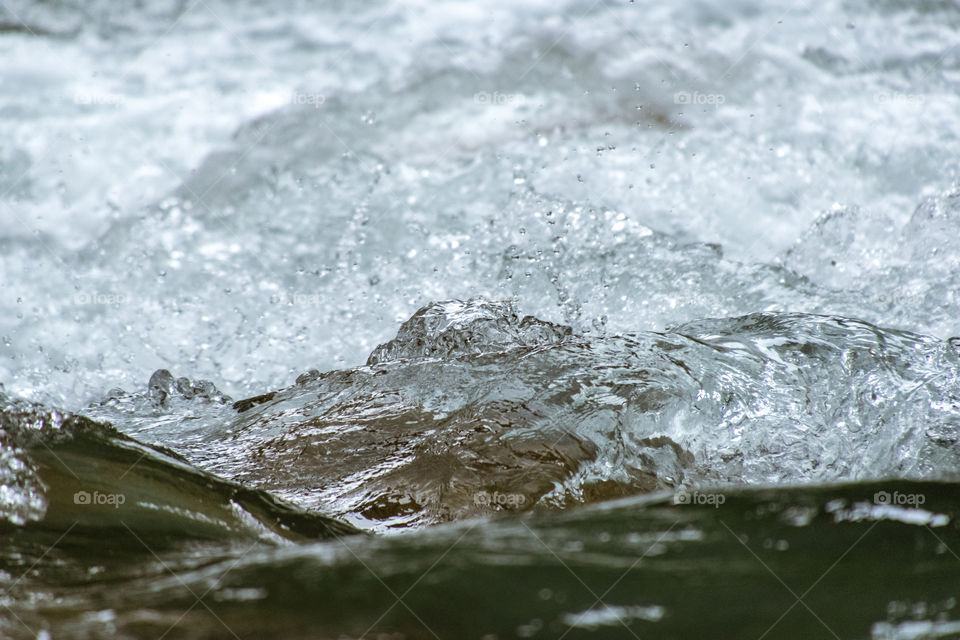 Little wave from fresh stream, clear and clean water from the nature