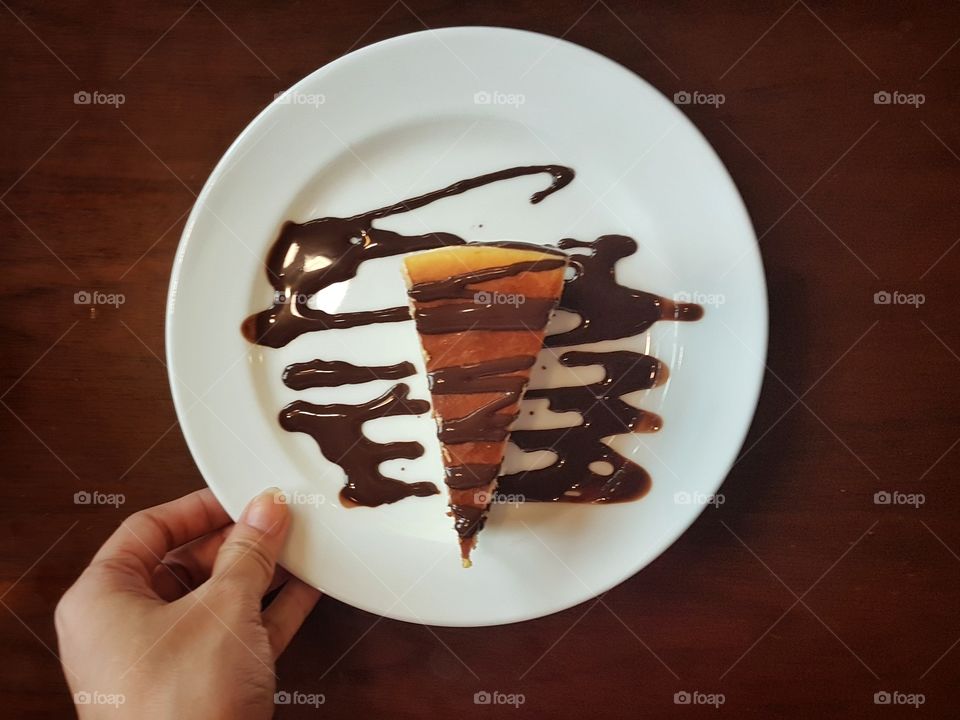 new york style cheesecake with chocolate syrup