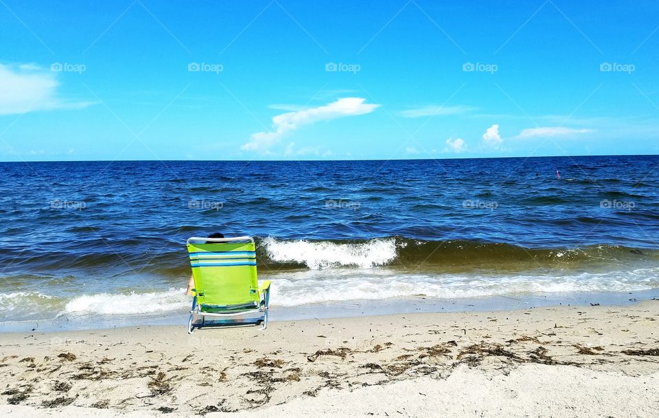 green beach chair and the ocean