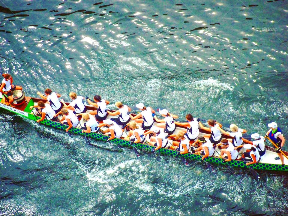 An all women dragon boat team paddle its way to the start line of their race.  More power to you, ladies!