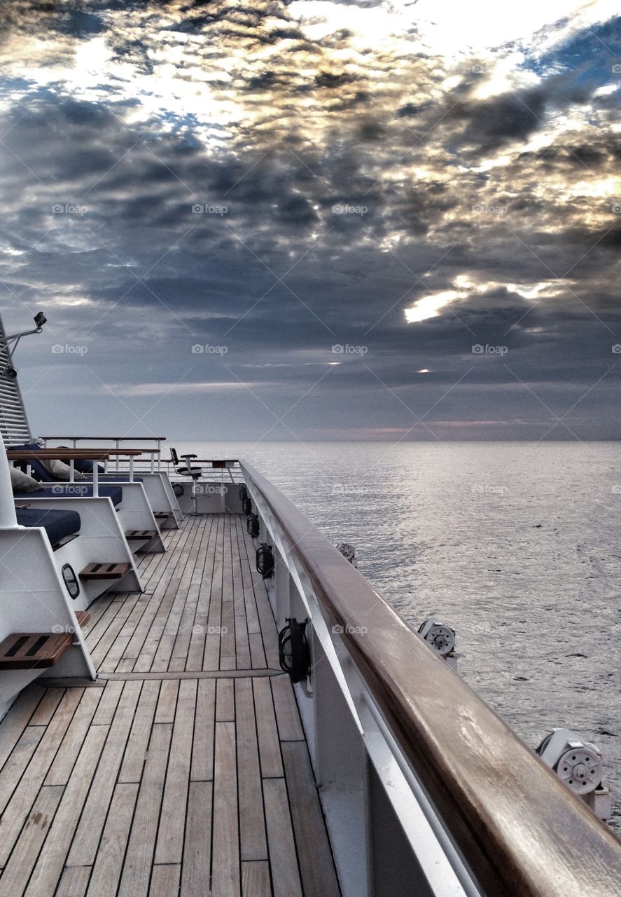 Dawn at sea. The sea clouds and yacht in the morning