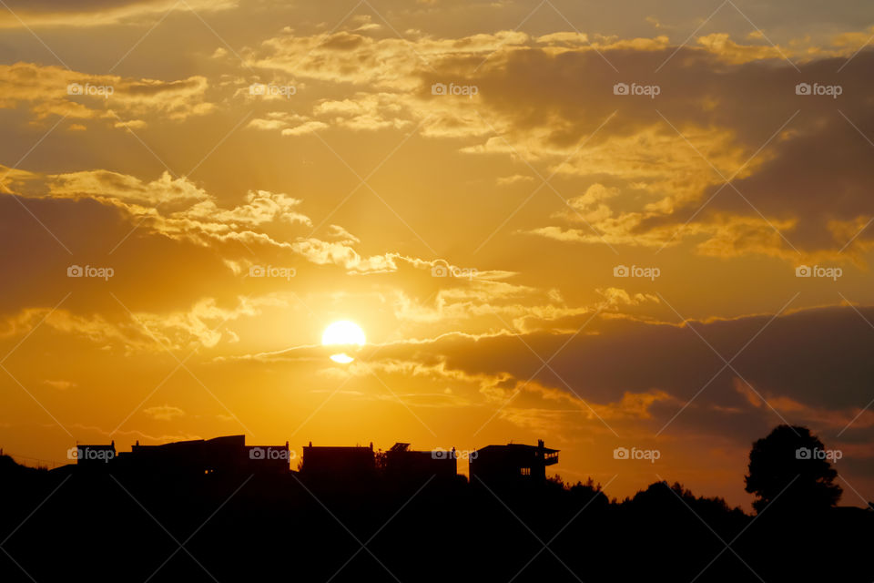 Beautiful sunset, cloudy sky and city silhouettes.