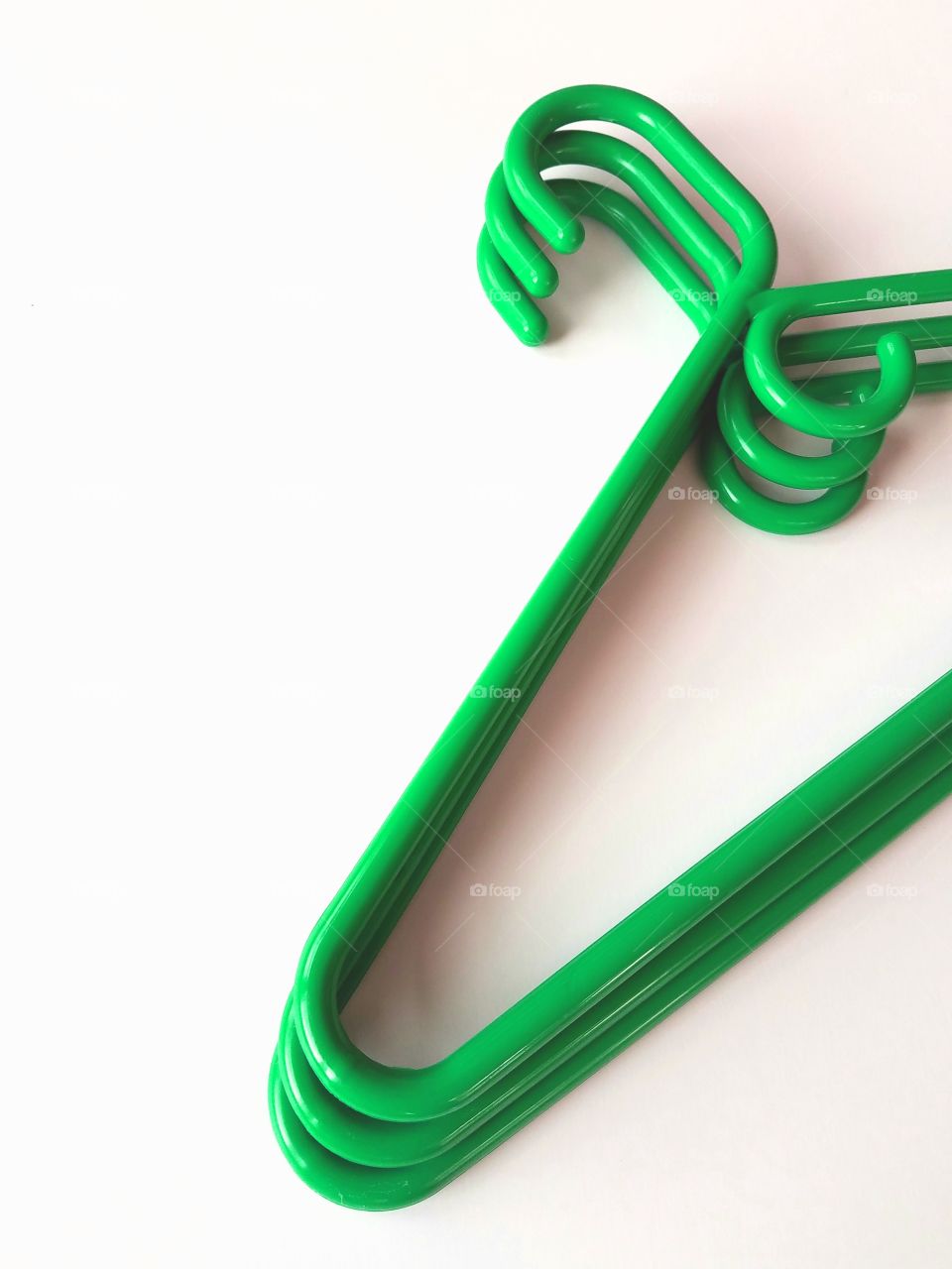 Green hanger on white background