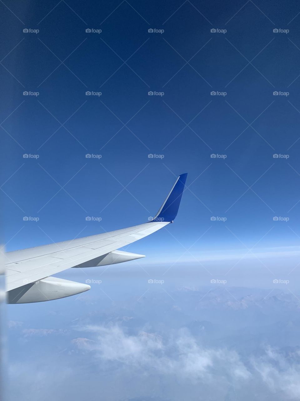 Delta airplane wing. Beautiful blue sky flying.