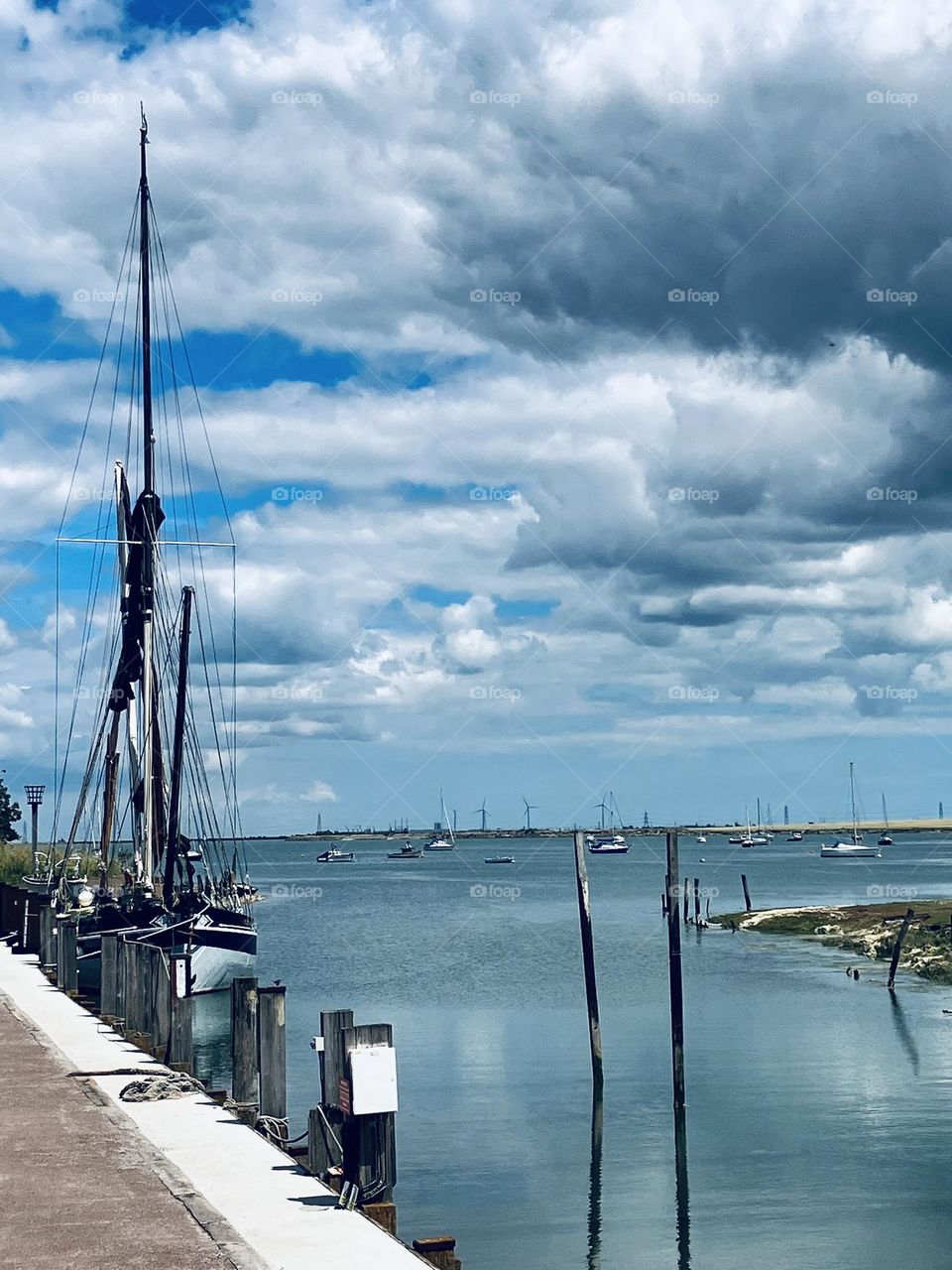A beautiful tiny harbour in a small English village. A beautiful sky with lots of character and calm glistening waters.