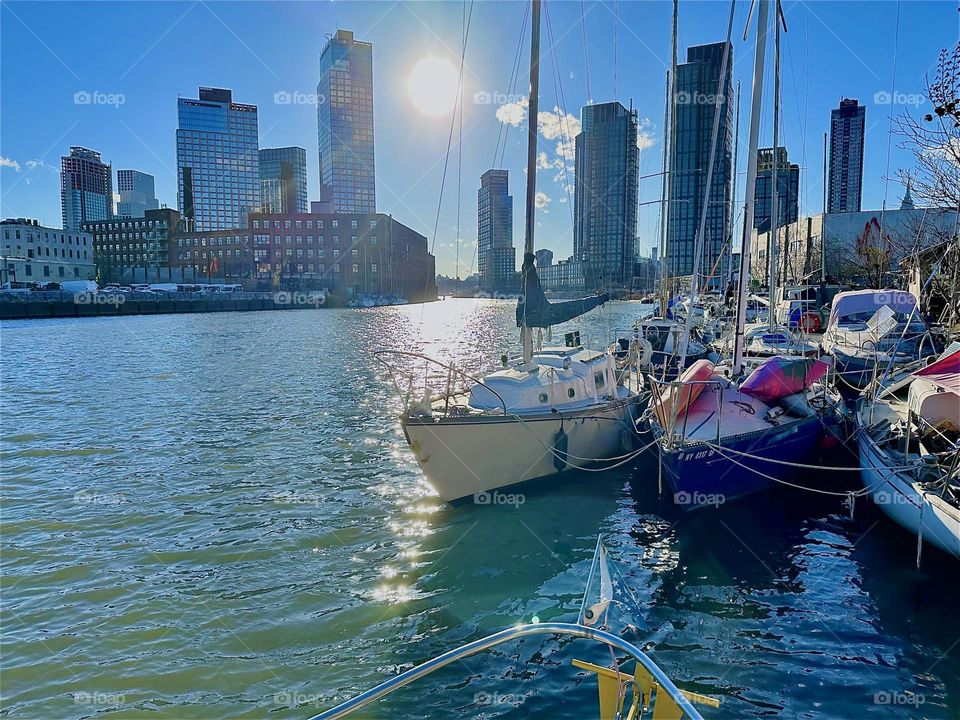 This is “Newtown Creek” by the “Pulaski Bridge” in LIC at the golden hour of sunset seen from our “28 ft 1969 Luhrs” cabin cruiser “Salvation”. We see “Greenpoint”, Bklyn to the left, LIC and “Manhattan” to the right. 2024. Hypnotic Productions
