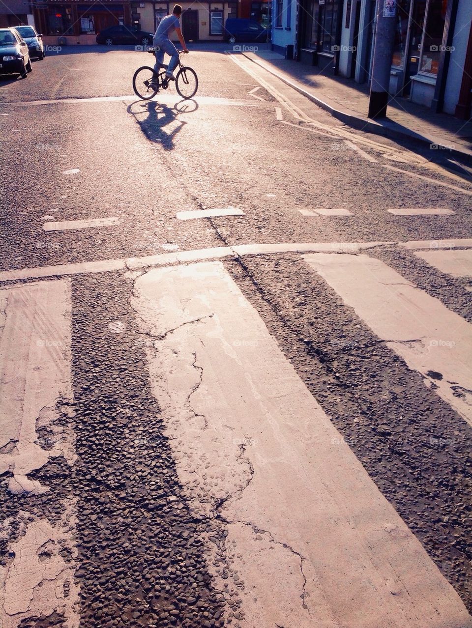 Cyclists shadows street crossing