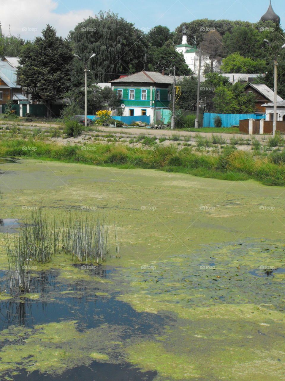 Colorful houses in Russia, by a pond