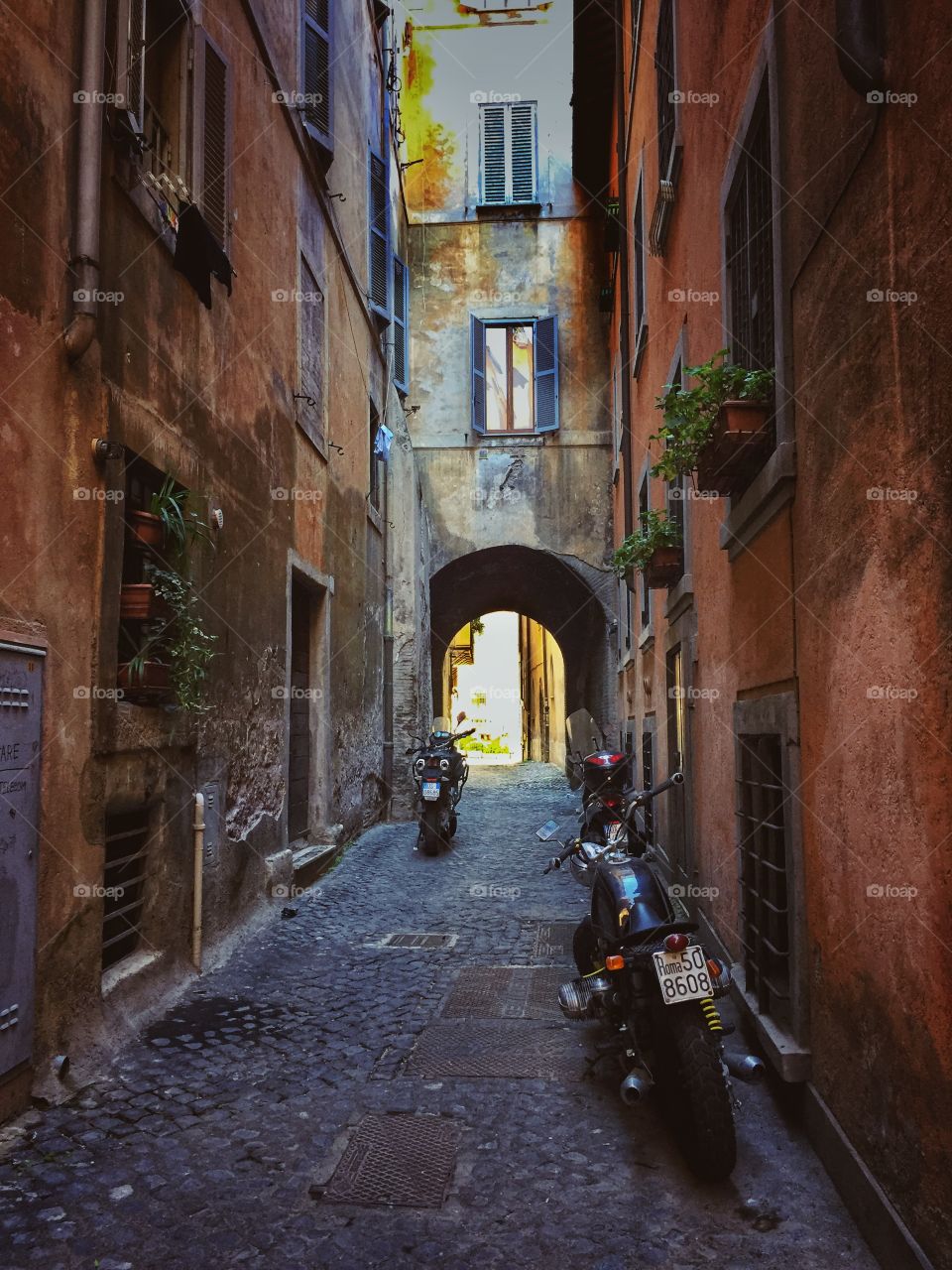 Motorcycles on a narrow street in Rome