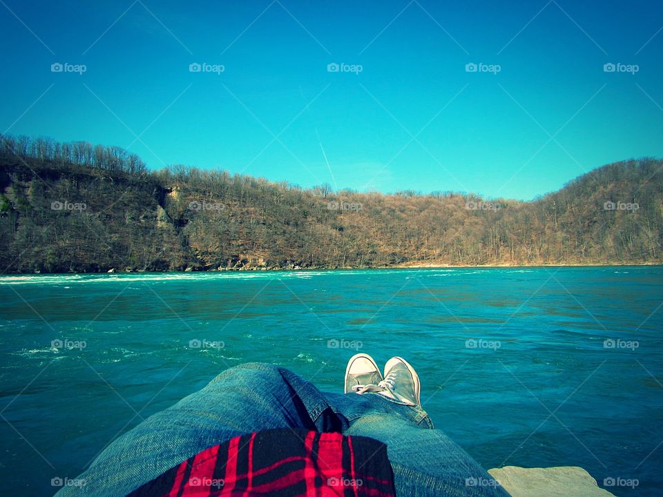 Laying on a rock, watching the Niagara Rapids rush past me