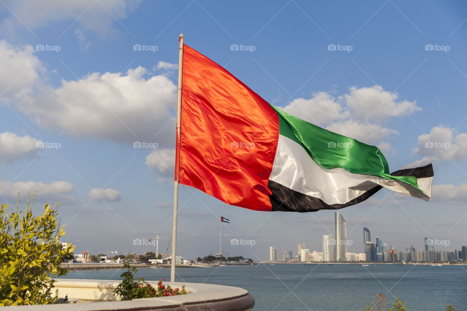 UAE flag with the background of Abu Dhabi