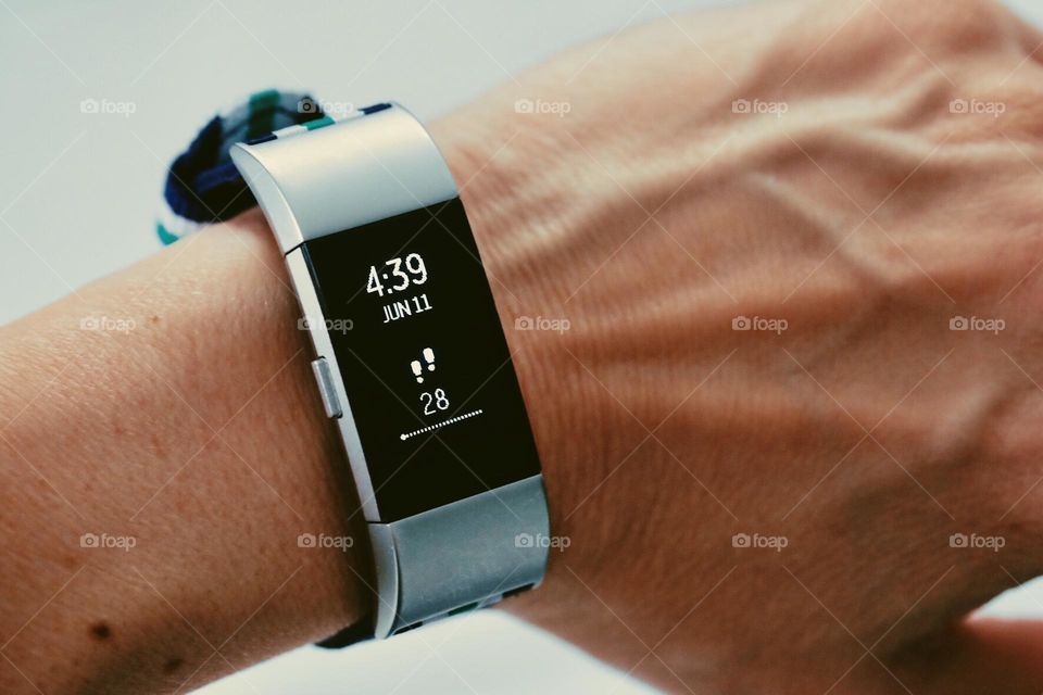 Wearing watches on wrist, woman’s wrist with Fitbit on, wearing trackable devices on your wrist 