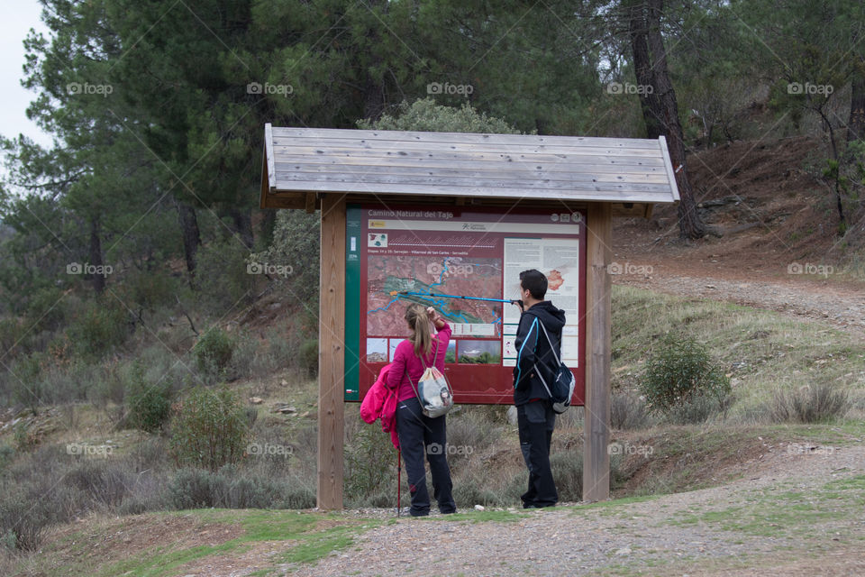 Boy and girl lost on the forest so they are looking a map