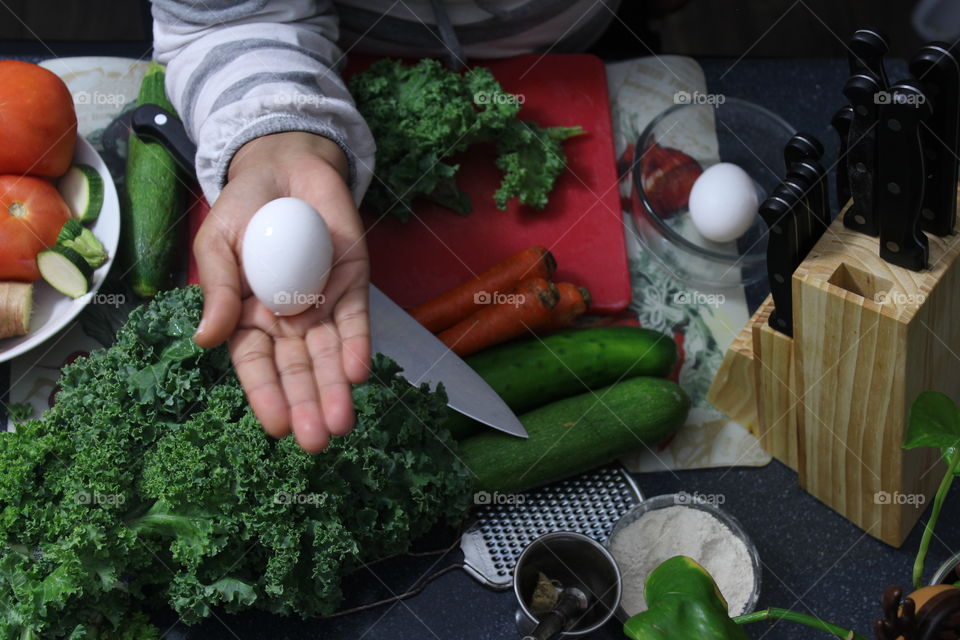 Preparing food in kitchen using vegetables and kitchen knife