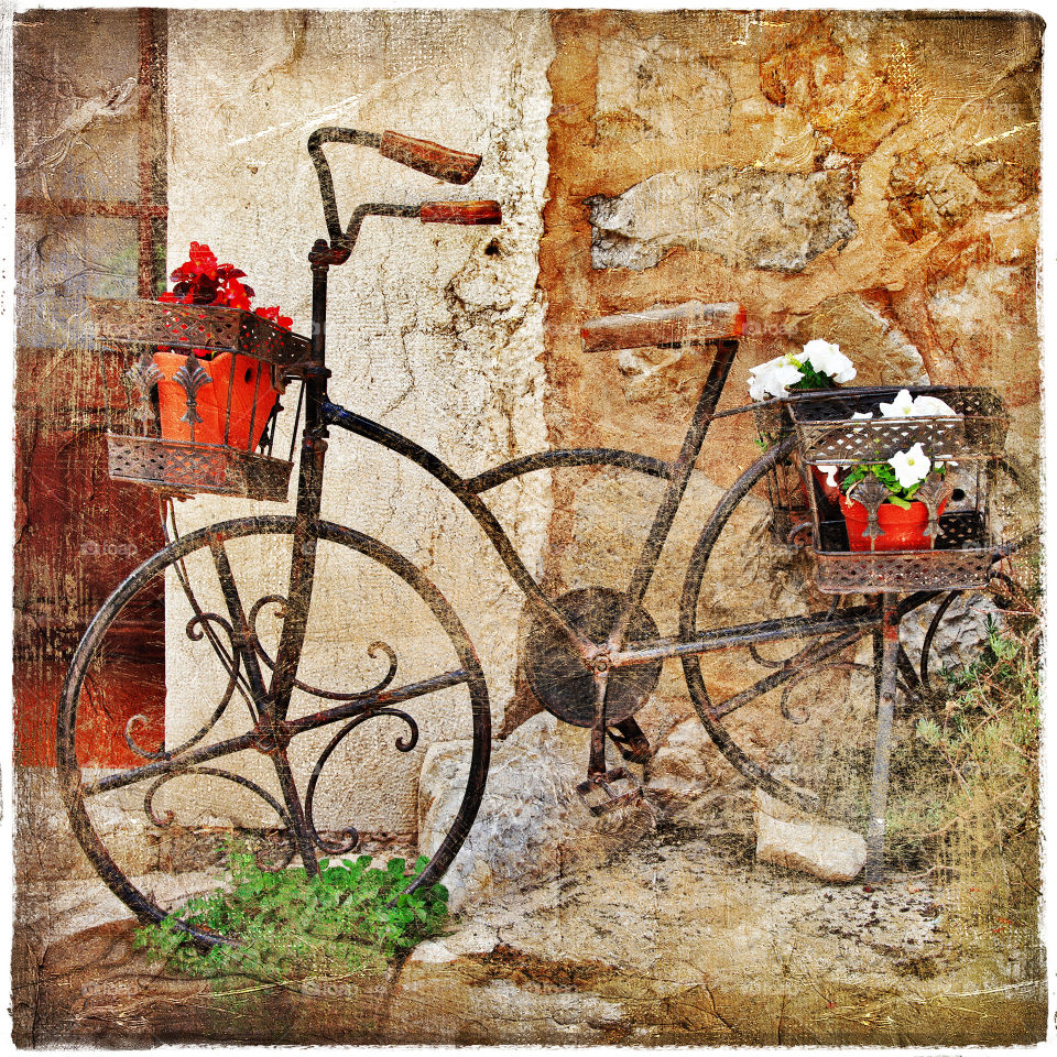Old school iron bike, antique leaning against old stone wall