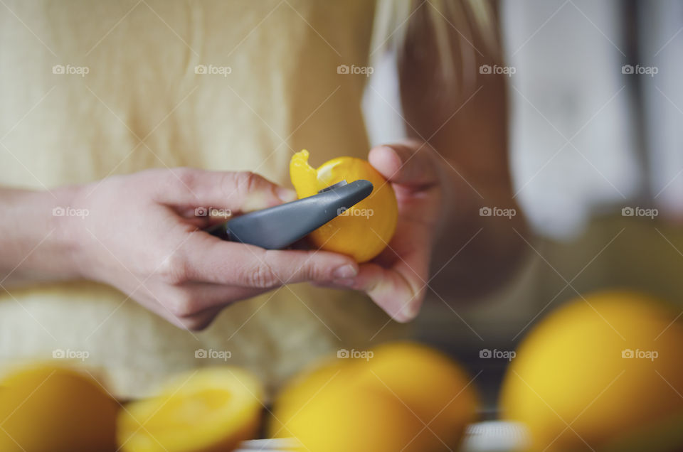 Peeling lemons for some sweet, zesty lemonade 