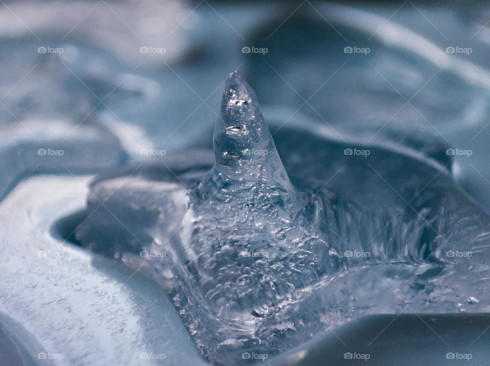 Air bubbles in a cold piece of ice.