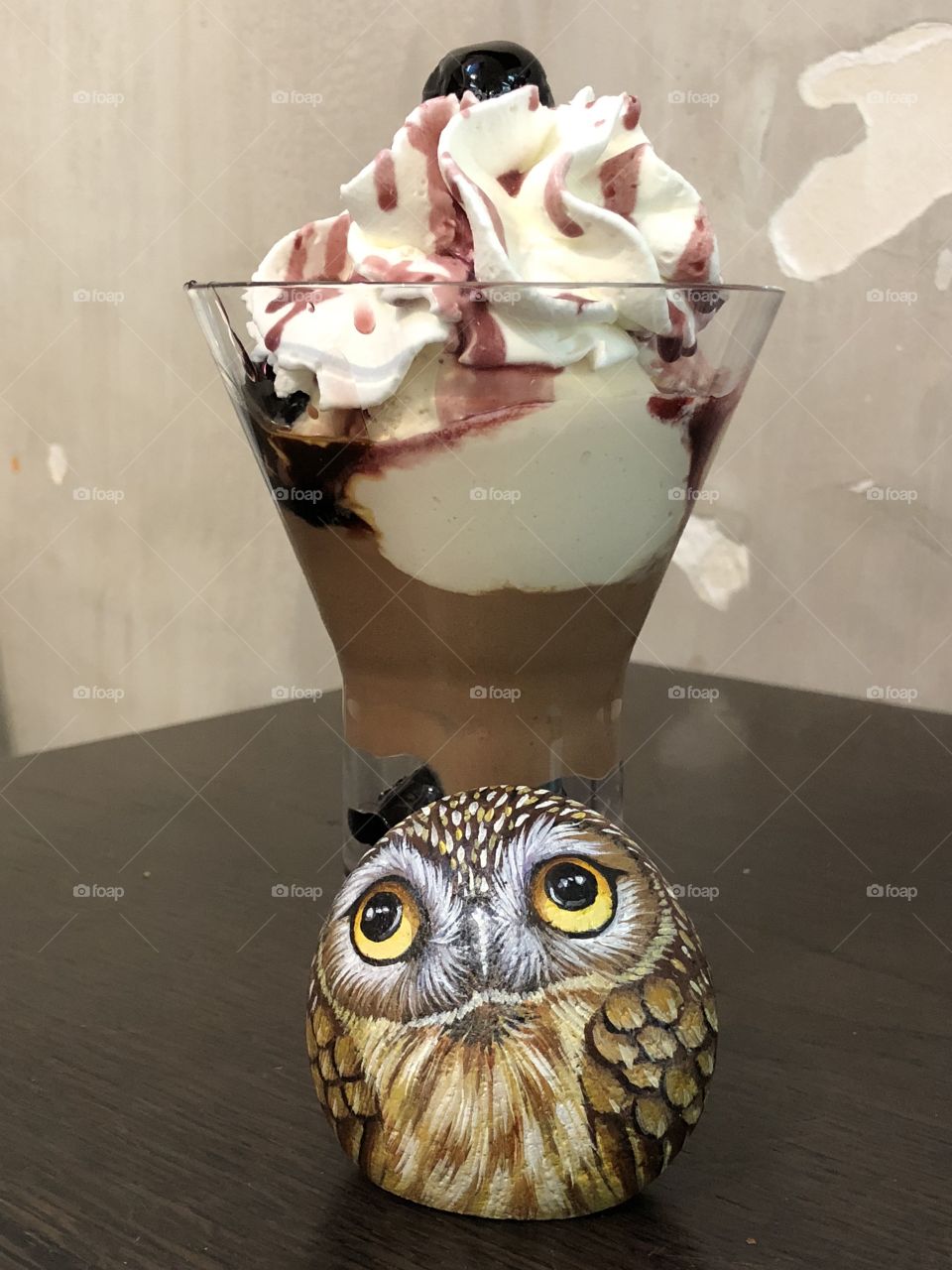 Italia ice cream with sour cherries and a stone owl