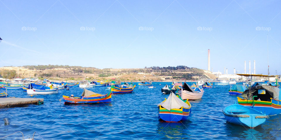 Harbor in Marsaxlokk Bay, with typical Maltese boat, I Luzzi