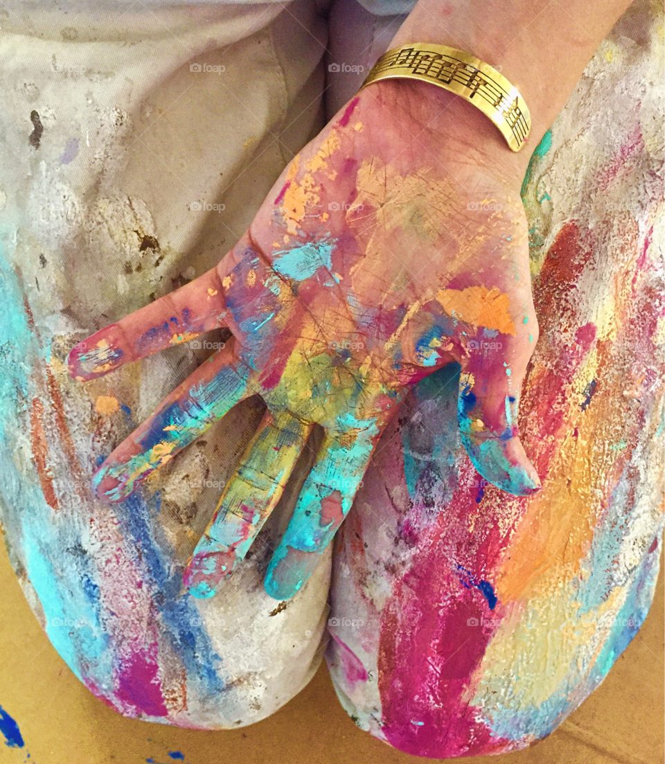 Artists hands after painting a mural.