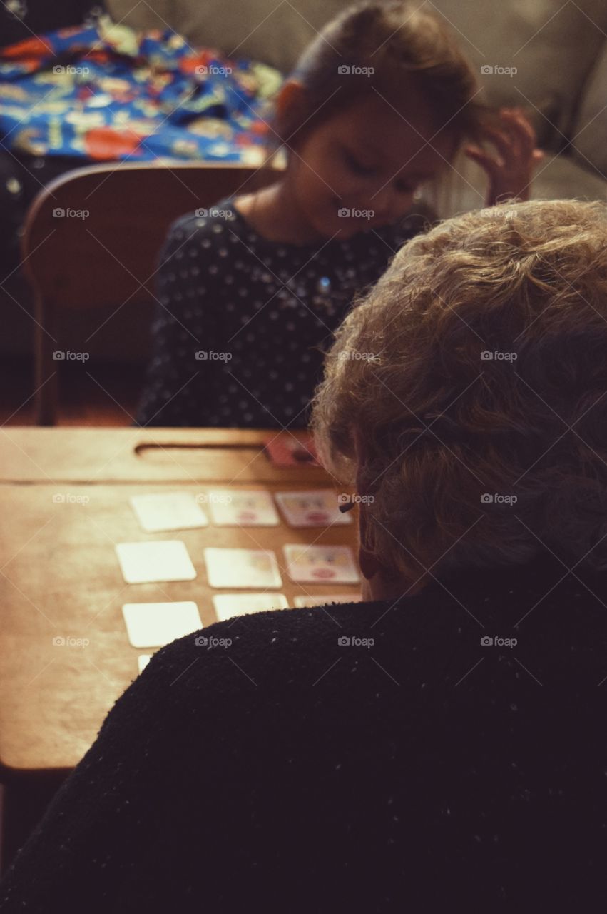 Grandmother and granddaughter playing card game