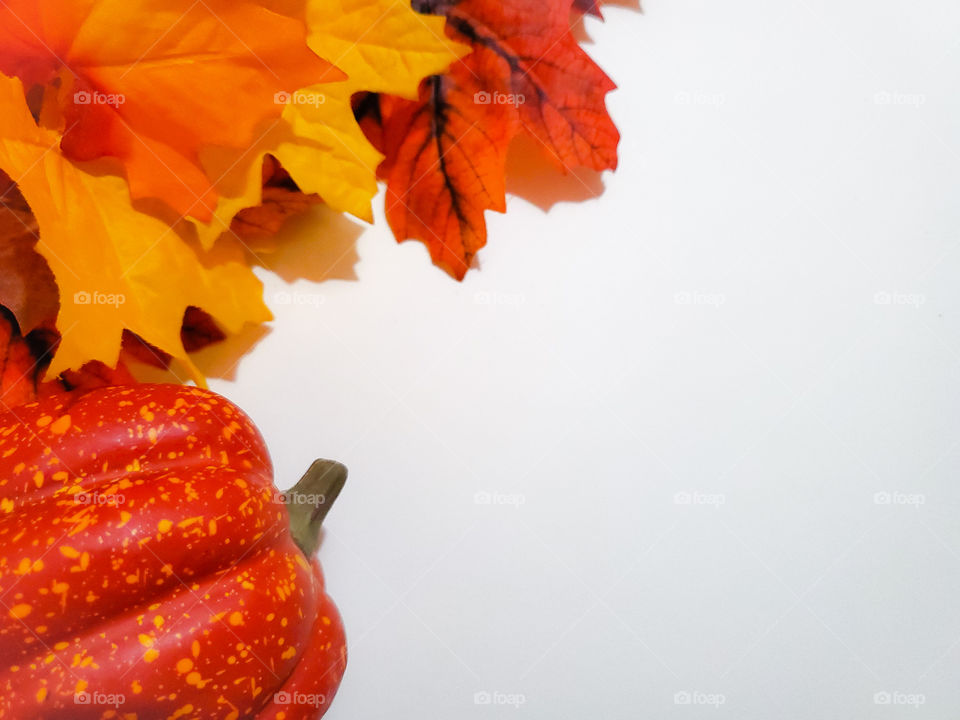 Fall leaves and pumpkin deco flat lay