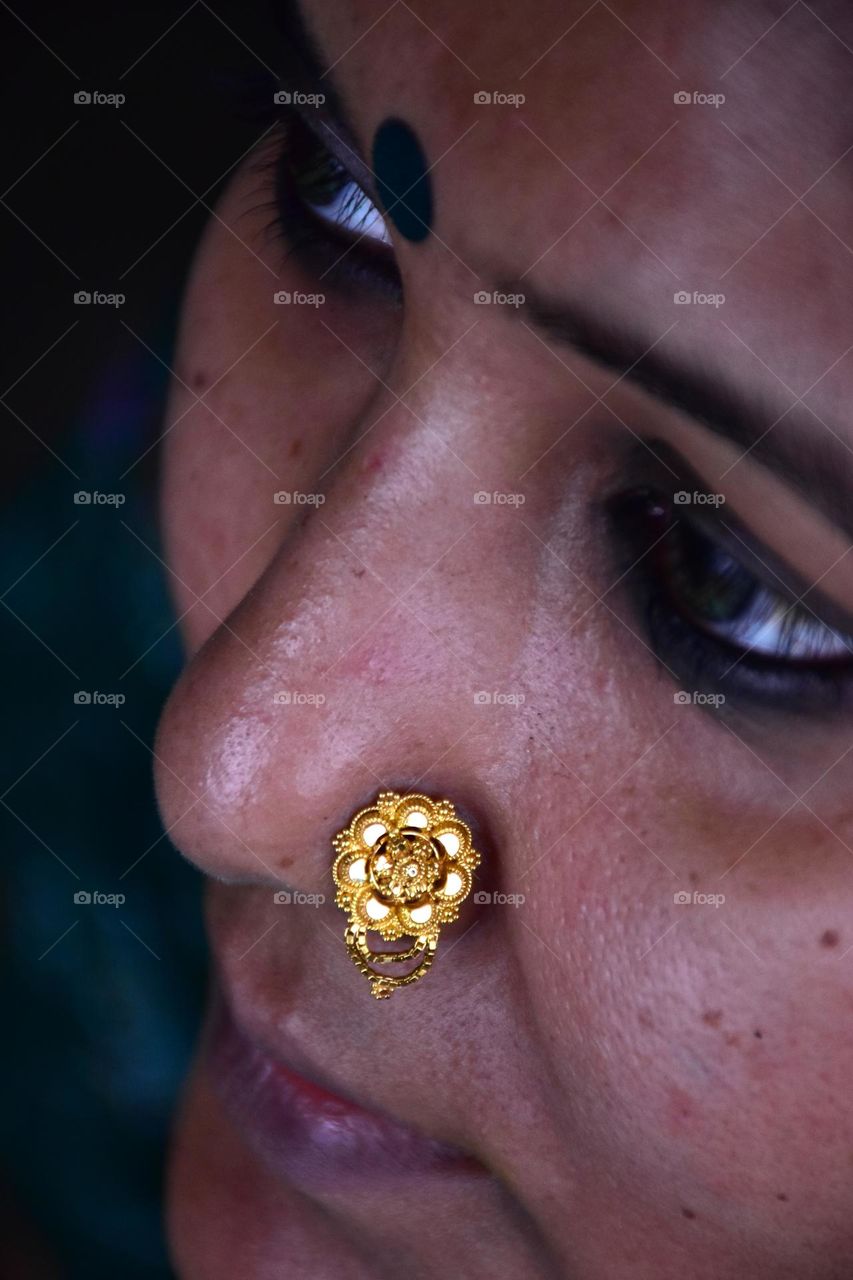 Indian woman wearing gold nose pin