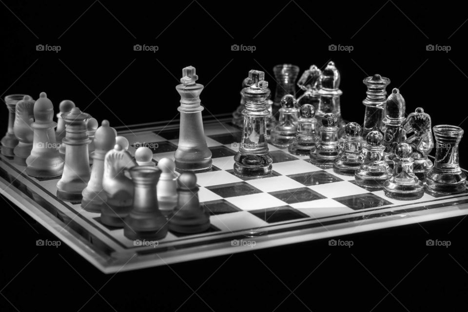 Crystal chess set lit from underneath.