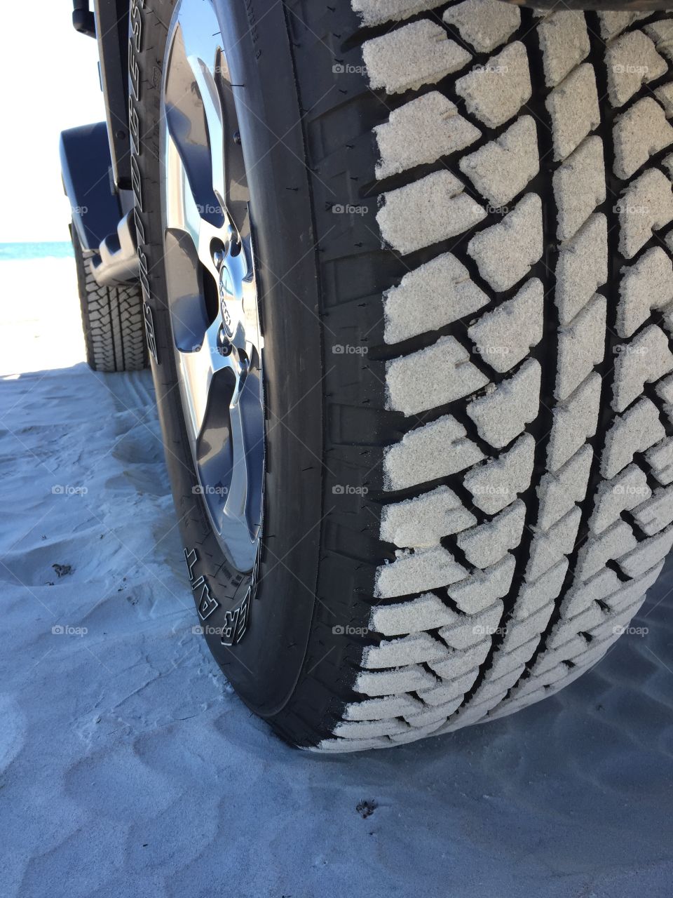 Jeep tire in the sand