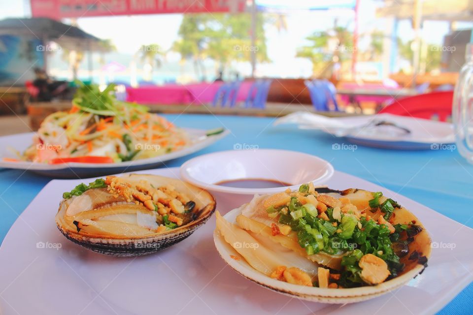 Grilled Scallop. Seafood with spicy sauce.