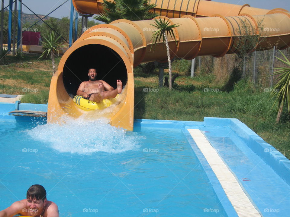 man with beard sliding down the tunel