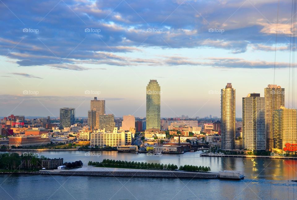 Cityscape of Long Island City. River view of Long Island City and the East river at dusk. Spectacular sunset shadows across the newly constructed condo