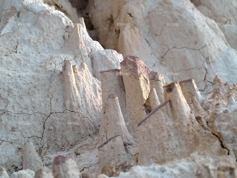 Natural erosion of rock and soil.