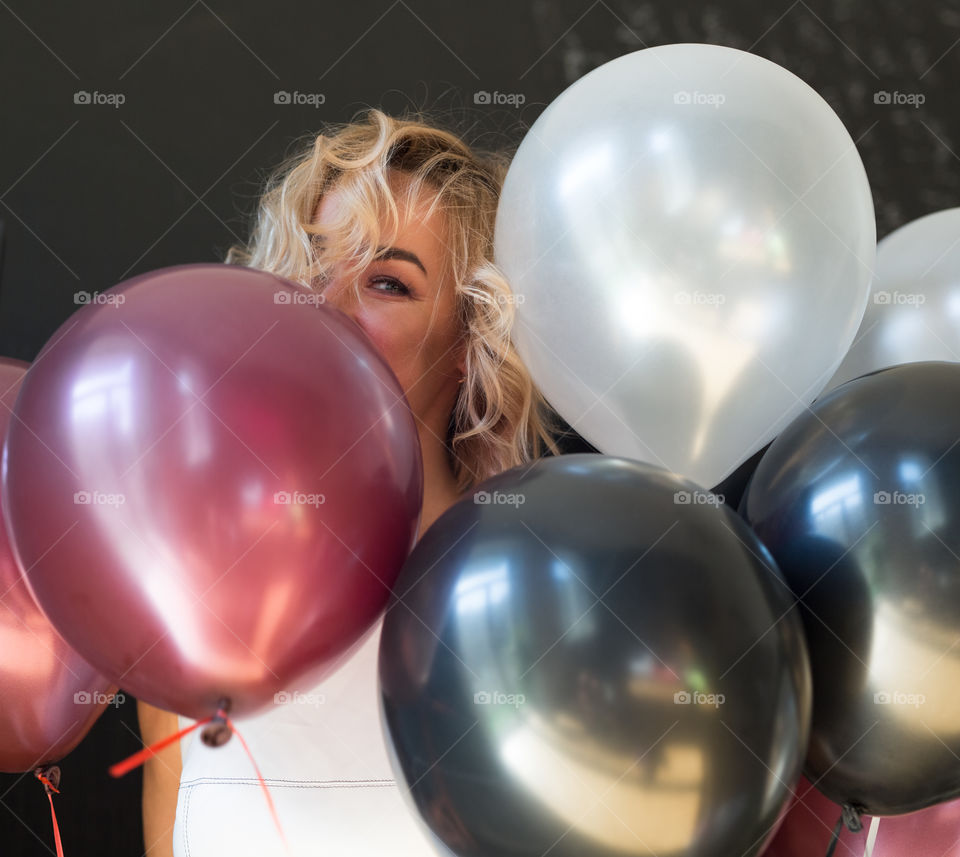 Happy sexy blond girl. Birthday girl. Girl walk at street with balloons 