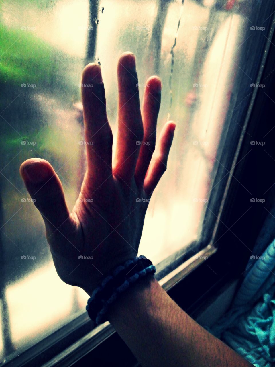 hand on window sill. after a rainstorm.