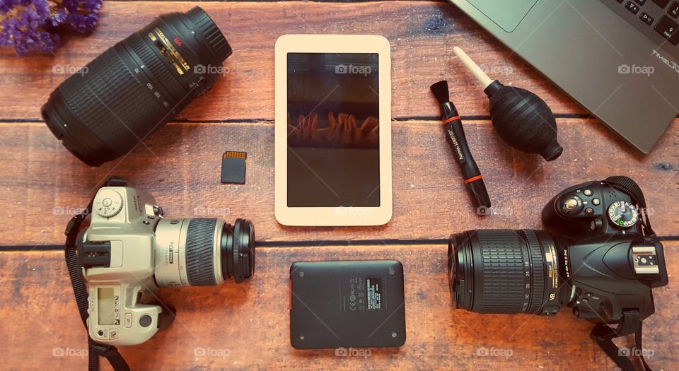 Photography equipment on a wooden desk.