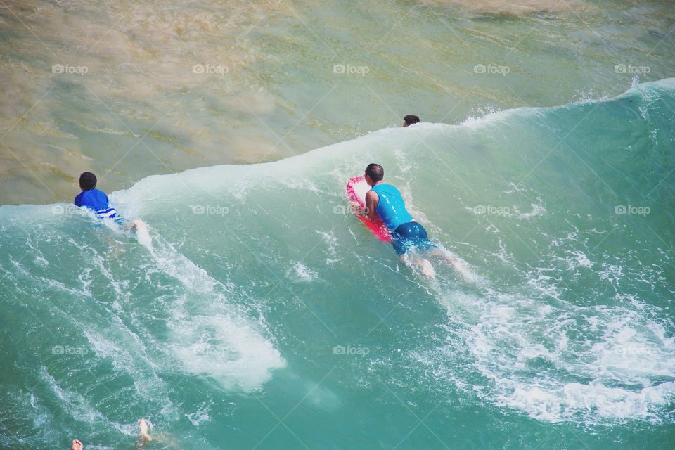 Boarding in the ocean with friends