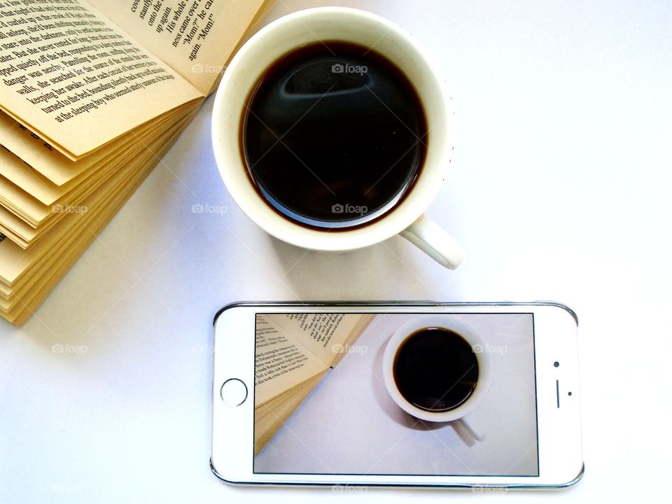 Coffee on the table with book and mobile phone